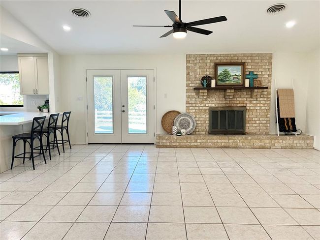 Statement brick fireplace surround and hearth, and plenty of room for furniture placement options | Image 4