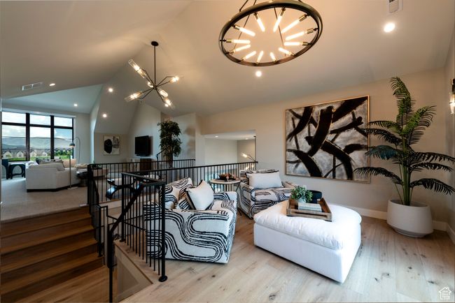 Living area featuring a chandelier, vaulted ceiling, wood finished floors, and recessed lighting | Image 41