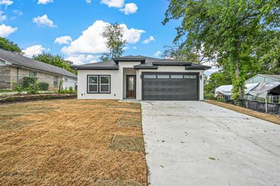 View of front of home with a garage and a front yard | Image 2