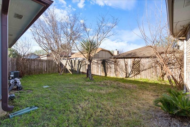 View of back yard featuring privacy fence & native landscaping | Image 21