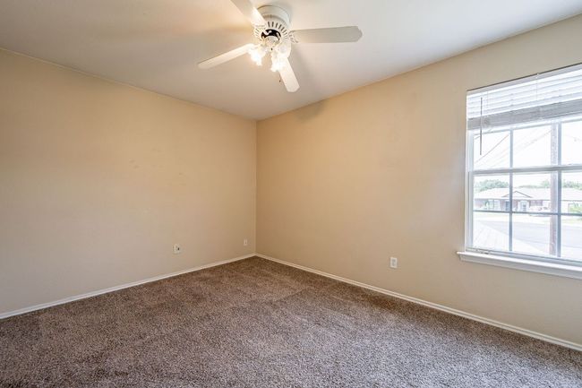 Carpeted spare room with a ceiling fan and baseboards | Image 25