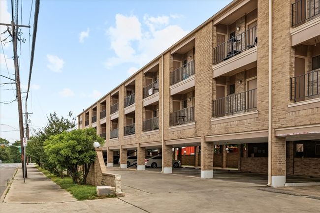 View of apartment building / complex featuring covered parking | Image 33