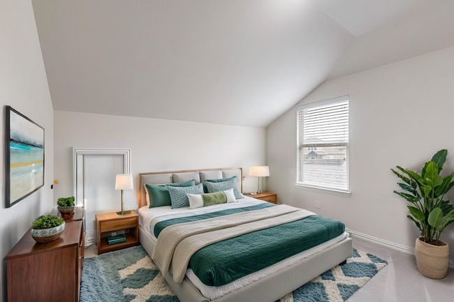 Carpeted bedroom with lofted ceiling and baseboards | Image 12