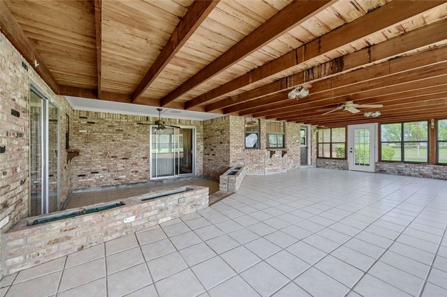 Unfurnished sunroom with beam ceiling | Image 32