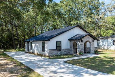 Modern farmhouse style home featuring a front lawn | Image 2