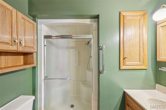 Bathroom featuring a shower stall and vanity | Image 24
