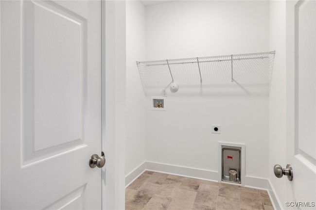 Convenient laundry room with built-in storage and space for full-size washer and dryer. | Image 21