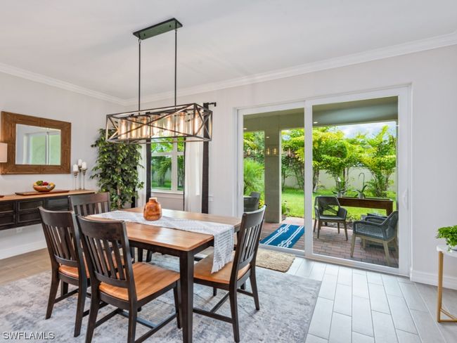 Entertain in style within the spacious dining area, adorned with a designer chandelier, offering ample room to host your cherished guests | Image 5