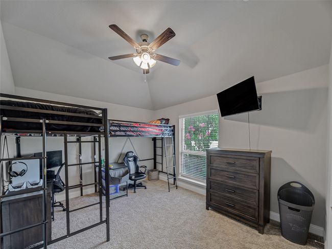 Carpeted bedroom featuring lofted ceiling and a ceiling fan | Image 28
