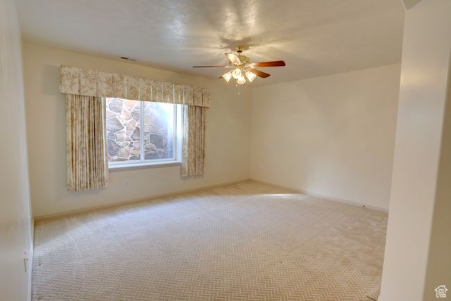 Carpeted empty room with baseboards, a ceiling fan, and visible vents | Image 35