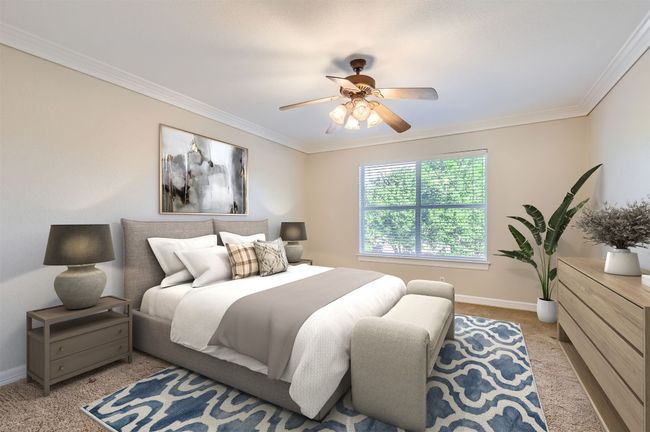 Bedroom with light colored carpet, a ceiling fan, baseboards, and ornamental molding | Image 28
