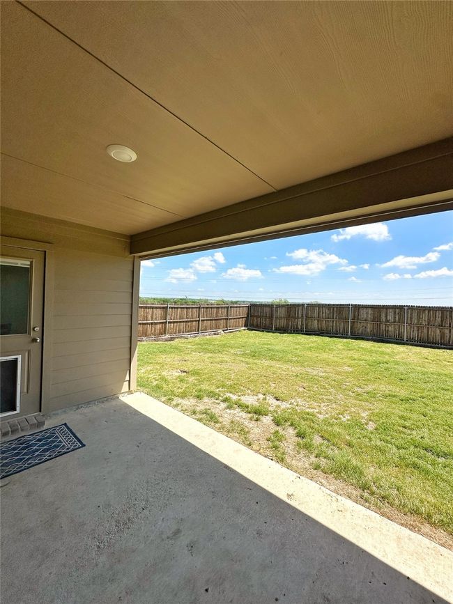 View of patio with a fenced backyard | Image 25