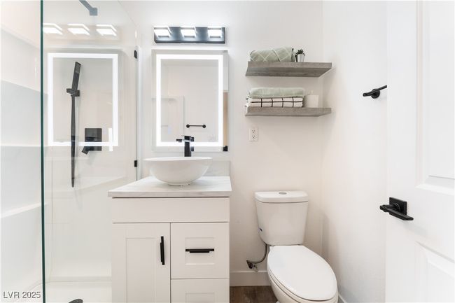 Bathroom featuring toilet, vanity, and a walk in shower | Image 22