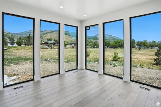 Unfurnished sunroom featuring a mountain view | Image 7