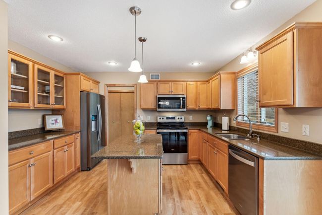 These beautiful maple cabinets are timeless. Note the coffee bar with cabinets above and below. Stainless steel and black appliances. | Image 5