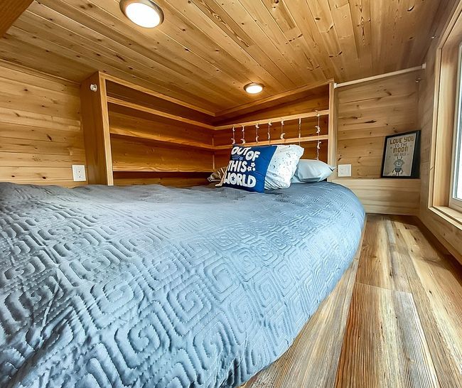 Bedroom featuring wooden ceiling, hardwood / wood-style flooring, and wood walls | Image 38