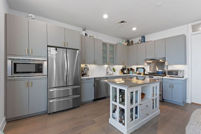 High-end appliances include a built-in microwave, recent LG fridge and gas range. | Image 14
