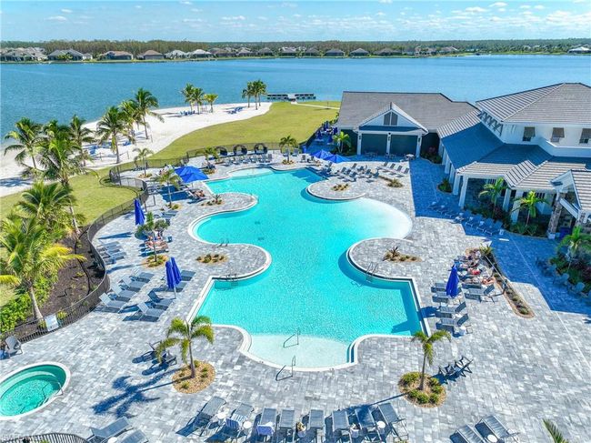 Community pool with a water view, fence, a community hot tub, and a patio | Image 31