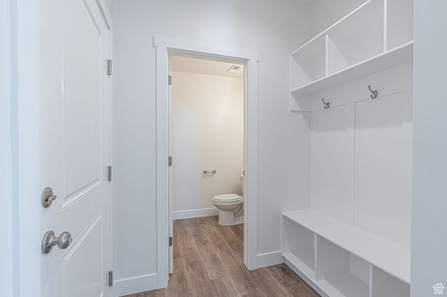 Mudroom with dark wood-style flooring and baseboards | Image 8