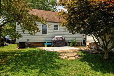 Back of property featuring a lawn, a patio area, and central air condition unit | Image 3