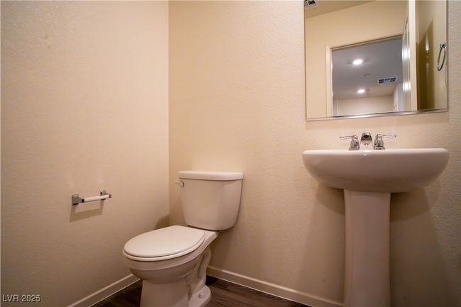Half bathroom with wood finished floors and toilet | Image 9