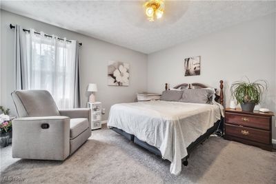 Bedroom featuring light carpet and a textured ceiling | Image 3