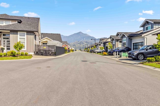 View of street featuring street lights, curbs, a mountain view, and a residential view | Image 11