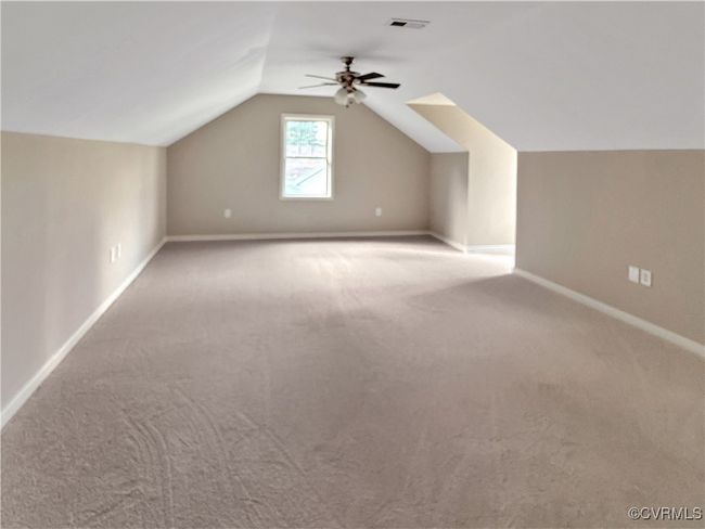 Bonus room featuring a ceiling fan, carpet flooring, and vaulted ceiling | Image 19