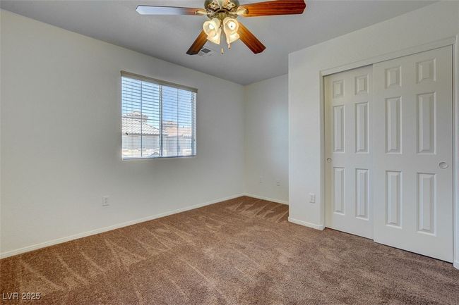 Unfurnished bedroom with a closet, carpet flooring, ceiling fan, and baseboards | Image 18