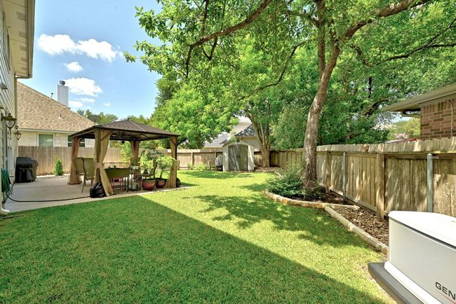 Fenced backyard with a gazebo, a patio area, and a storage unit | Image 30