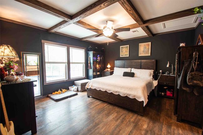 Master Bedroom featuring coffered ceiling, wood finished floors, beamed ceiling, and a ceiling fan | Image 13