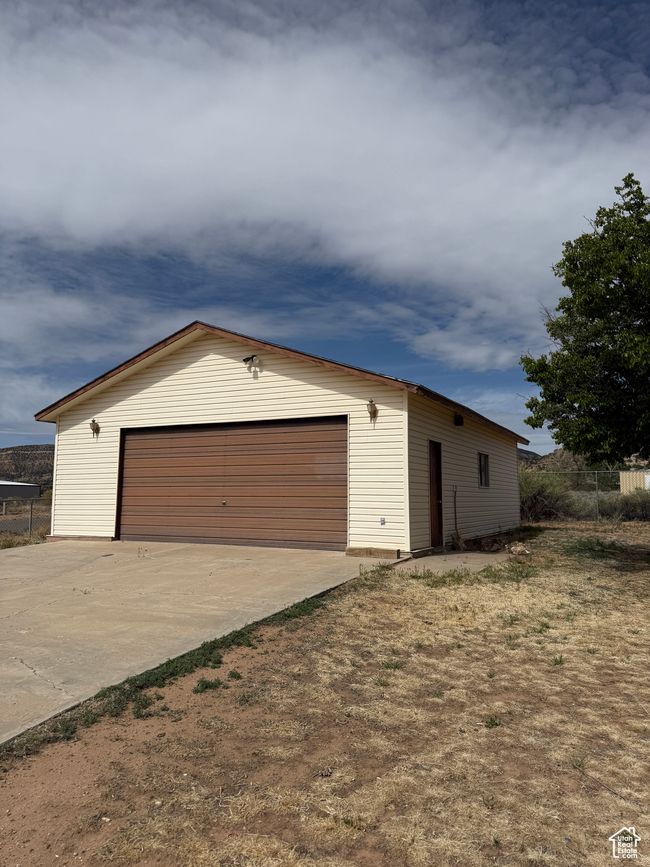 Detached garage featuring fence | Image 19