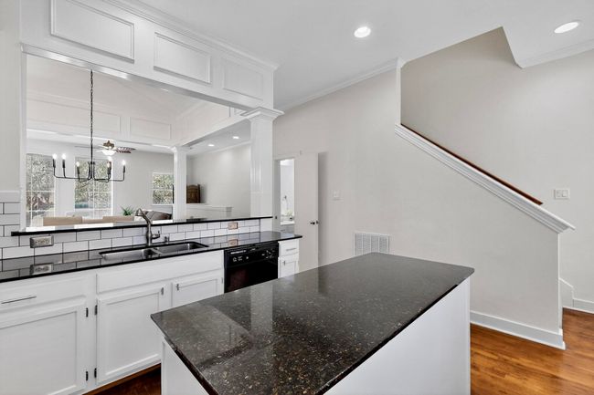 Kitchen featuring ornamental molding, recessed lighting, dark wood finished floors, white cabinetry, and a chandelier | Image 17
