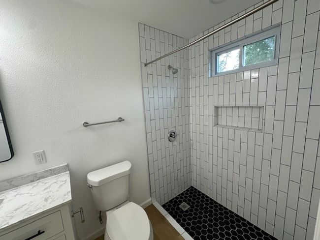 Full bathroom featuring vanity, toilet, and tiled shower | Image 21