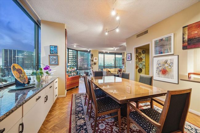 The built-in cabinetry provides an ideal serving area, featuring a sleek granite countertop and storage below. | Image 11
