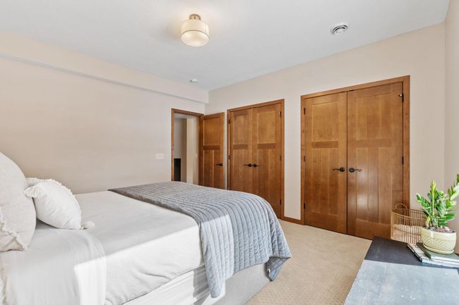 To complete the lower level, you will find another large bedroom and full bathroom, perfect for guests. | Image 62