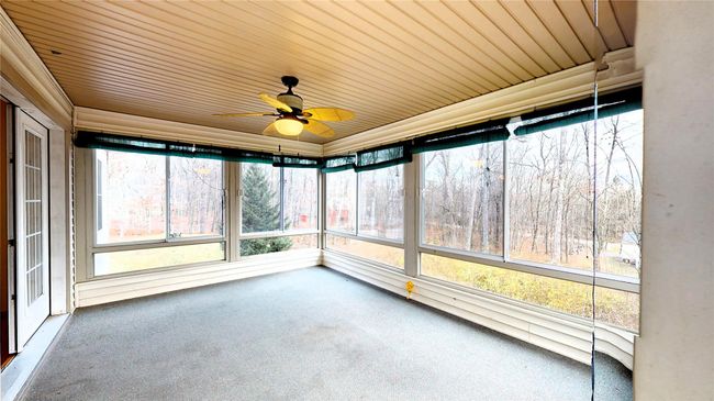 Unfurnished sunroom with wood ceiling and a ceiling fan | Image 12