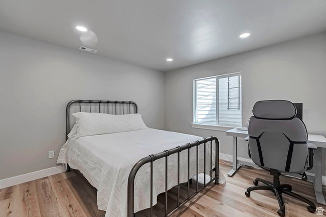 Bedroom featuring light wood-type flooring, baseboards, and recessed lighting | Image 24