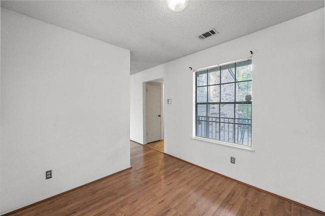 Spare room with wood finished floors and a textured ceiling | Image 4