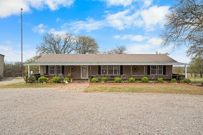 View of front of house with covered porch, a front lawn, and roof with shingles | Image 36