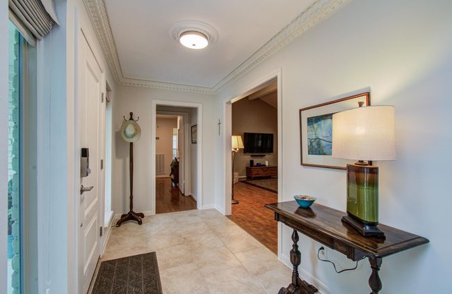 Greet your guests in this spacious foyer framed with crown molding and windows that soak in the daylight. | Image 4