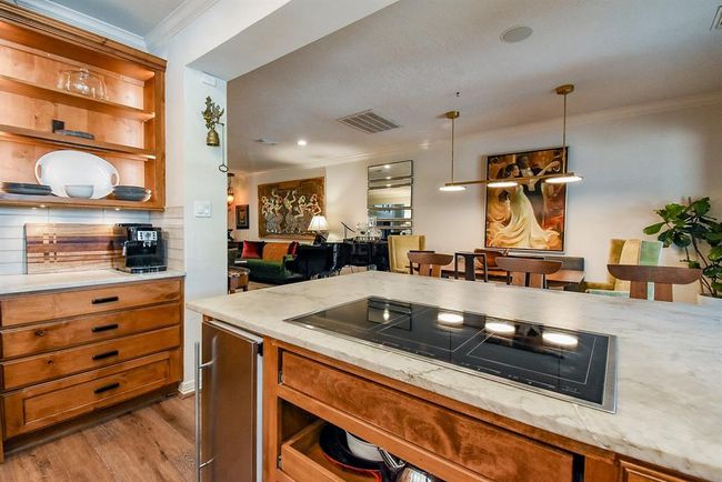 So easy to cook for your guests on this induction cooktop, while conversering with them, truly an inviting kitchen! Notice the ice maker! | Image 18