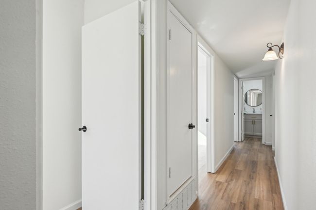 Hallway featuring light wood finished floors and baseboards | Image 12