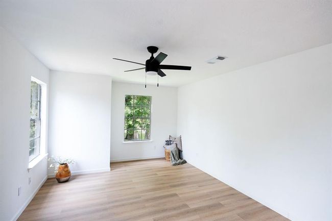 Spacious primary bedroom with abundant natural light. | Image 22