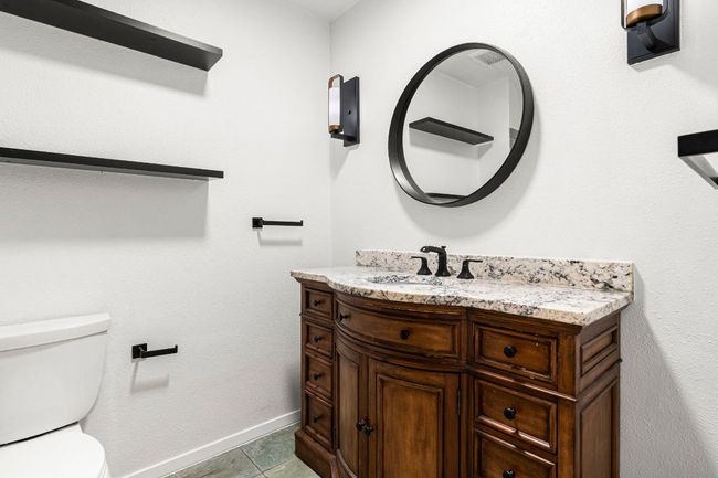 Bathroom featuring toilet and vanity | Image 25