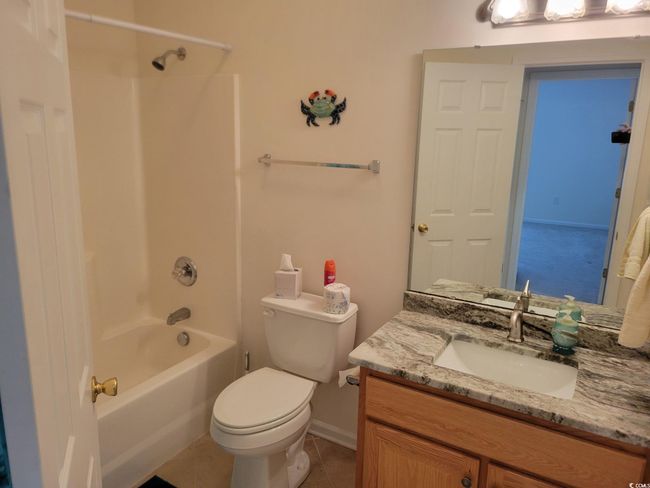 Bathroom featuring vanity, shower / bathtub combination, and tile patterned flooring | Image 16