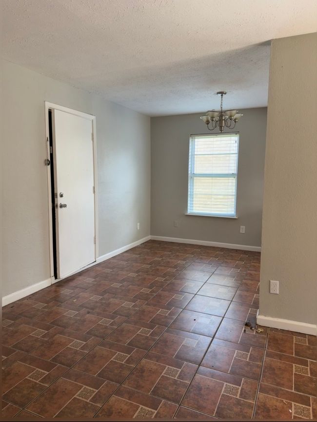 Spare room with a chandelier and a textured ceiling | Image 7