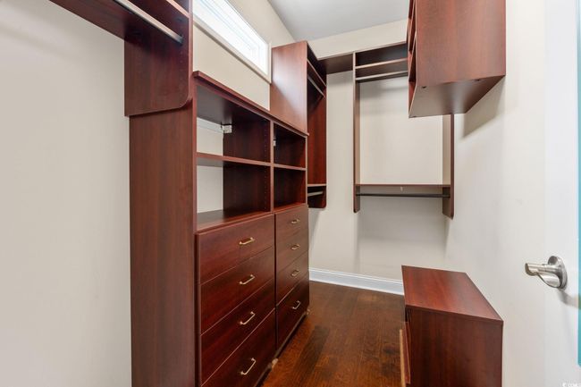 Spacious closet featuring dark wood-type flooring | Image 24