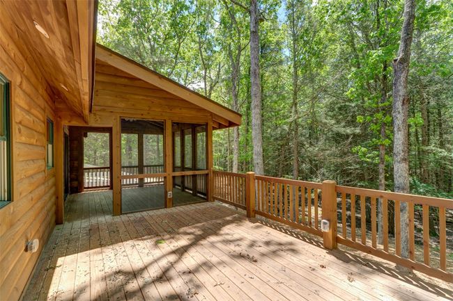 Wooden deck featuring a wooded view | Image 40