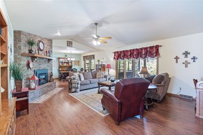 Living room with view of beautiful fireplace and also of the dining room | Image 3